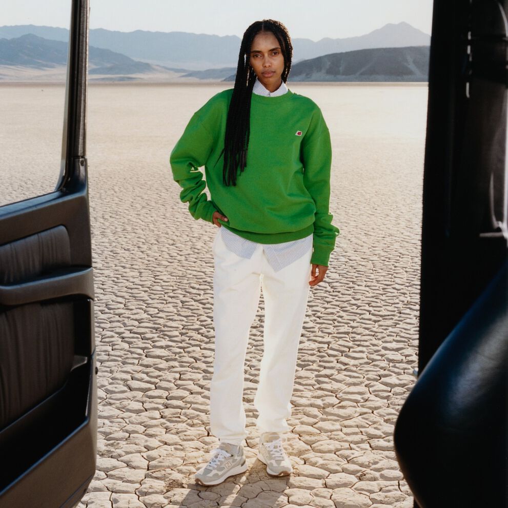 A man standing in a desert environment. 